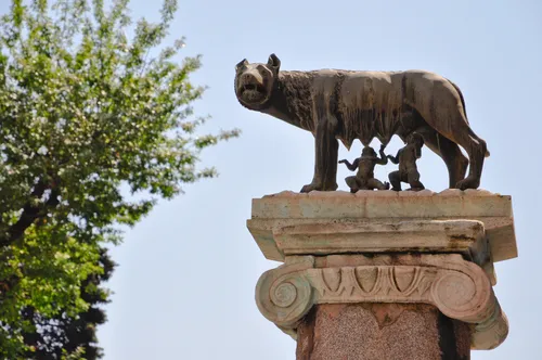 statue on a column of the luperca with romulus and remus